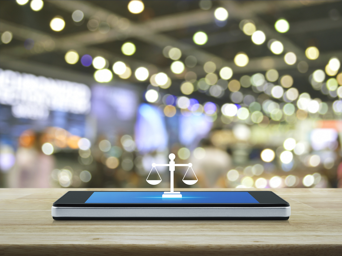 Law flat icon on modern smart mobile phone screen on wooden table over blur light and shadow of shopping mall, Business legal service online concept